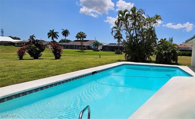 view of pool featuring a lawn