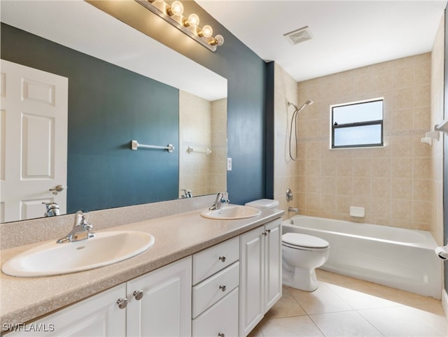 full bathroom with tiled shower / bath combo, vanity, toilet, and tile patterned flooring