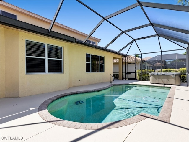 view of swimming pool with a lanai, a hot tub, and a patio