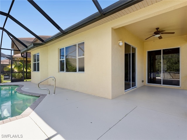 back of property featuring a lanai, a patio area, and ceiling fan