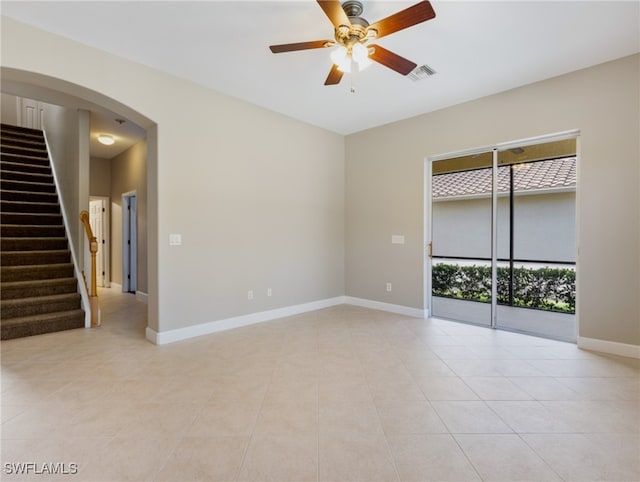 tiled empty room with ceiling fan