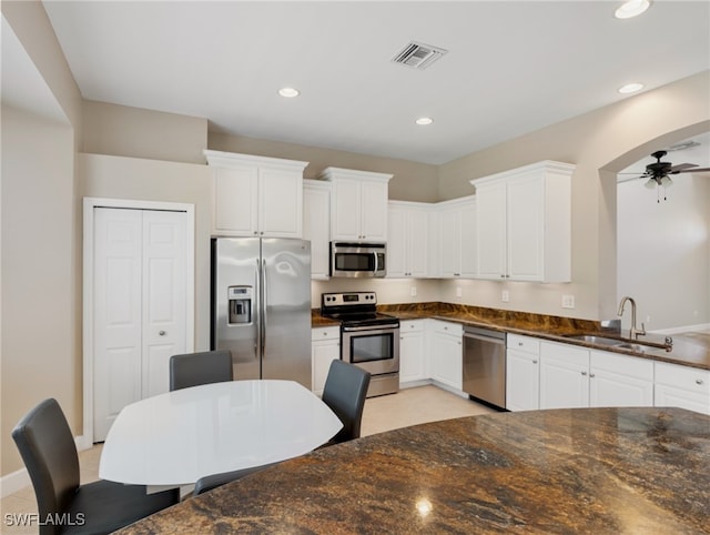 kitchen featuring white cabinets, ceiling fan, stainless steel appliances, and sink