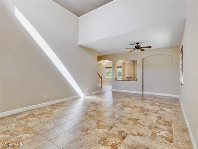 unfurnished living room with ornamental molding and ceiling fan