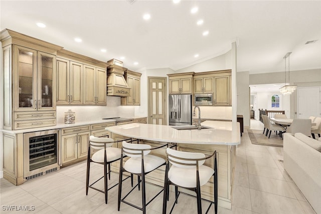 kitchen featuring a breakfast bar, a sink, stainless steel appliances, a large island, and wine cooler