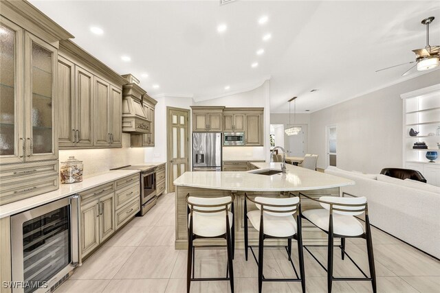 kitchen with sink, stainless steel appliances, wine cooler, a large island with sink, and pendant lighting