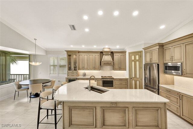 kitchen featuring a breakfast bar, premium range hood, sink, a large island, and stainless steel appliances