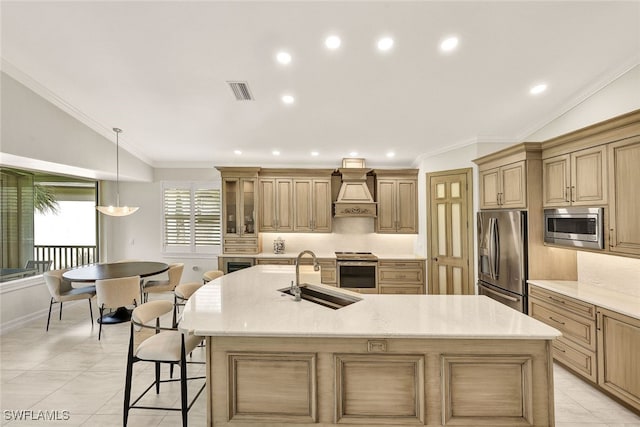 kitchen with visible vents, premium range hood, a spacious island, a sink, and appliances with stainless steel finishes