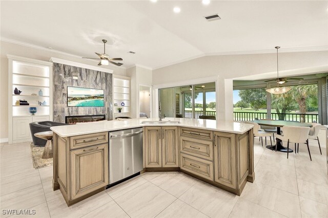 kitchen featuring built in features, stainless steel dishwasher, hanging light fixtures, and a kitchen island with sink