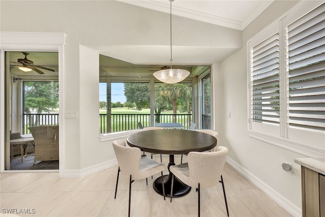 dining area with ceiling fan, light tile patterned flooring, crown molding, and vaulted ceiling