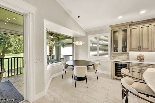 dining room featuring ornamental molding, vaulted ceiling, beverage cooler, ceiling fan, and light tile patterned floors