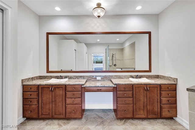 bathroom with vanity and a tile shower