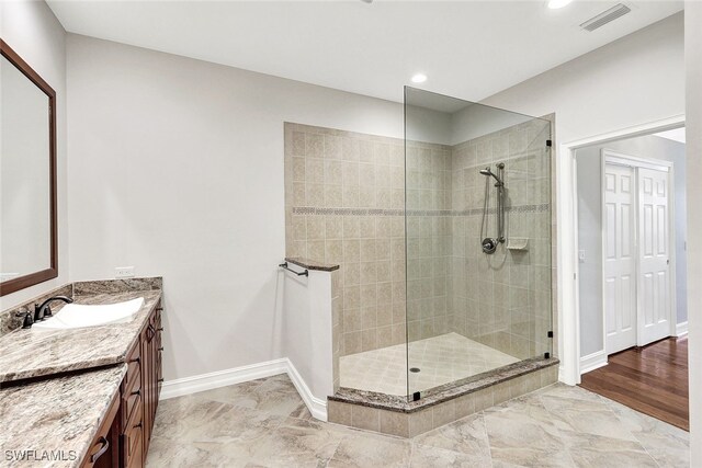 bathroom featuring vanity and a tile shower