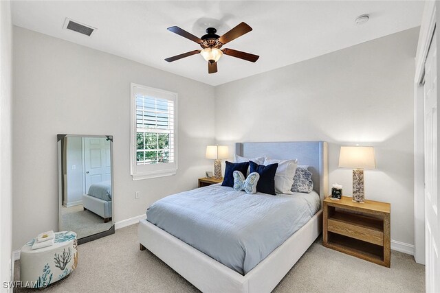 bedroom featuring light colored carpet and ceiling fan