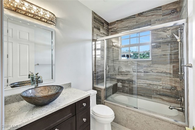 full bathroom featuring vanity, toilet, and enclosed tub / shower combo