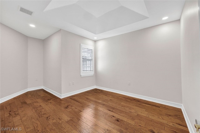 empty room with recessed lighting, visible vents, baseboards, and hardwood / wood-style flooring