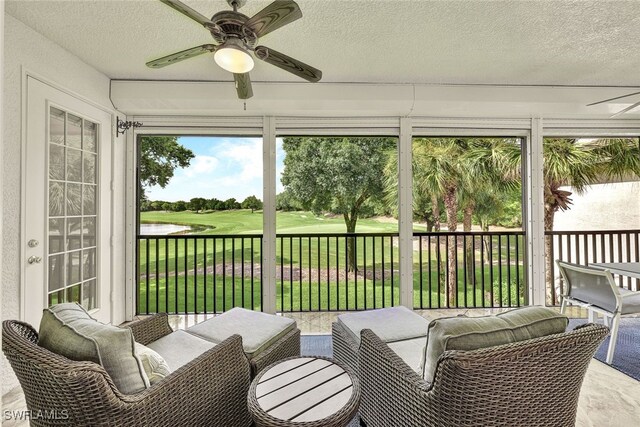 sunroom featuring ceiling fan