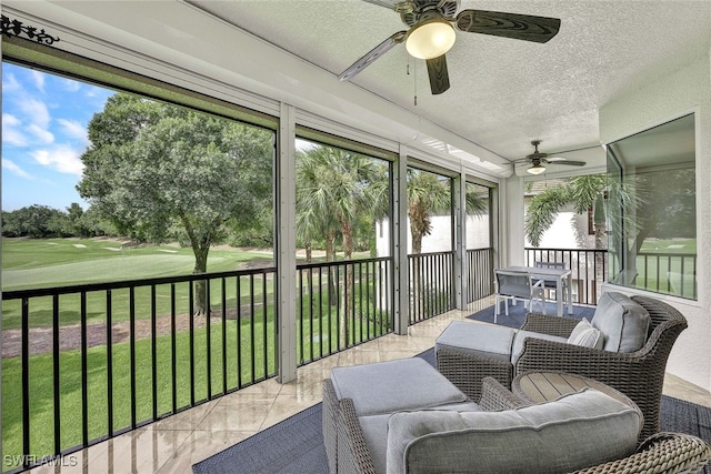 sunroom / solarium featuring ceiling fan