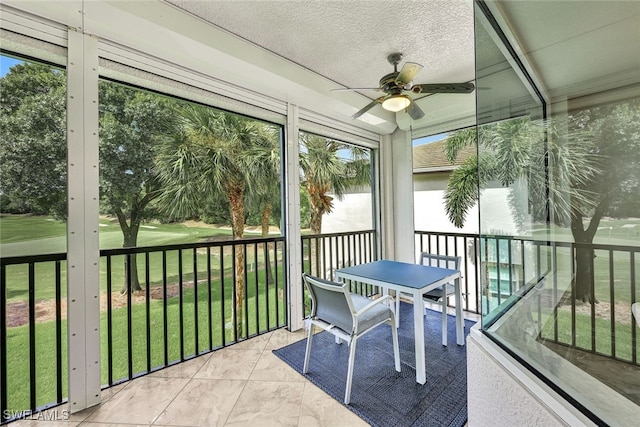 sunroom / solarium with a ceiling fan