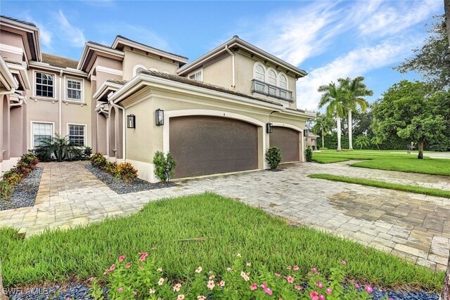 view of front of property with a front yard and a garage