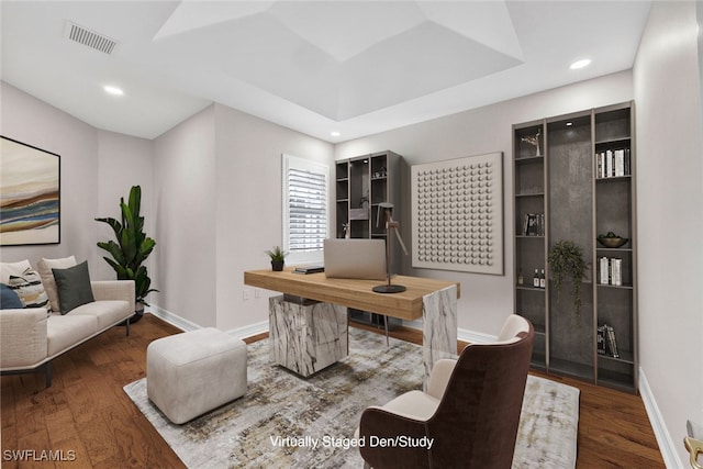 office with hardwood / wood-style flooring and a tray ceiling