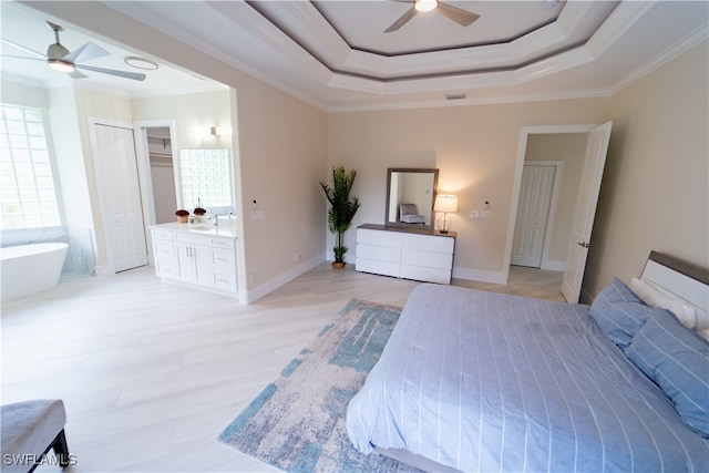 bedroom featuring ornamental molding, ensuite bath, light wood-type flooring, and ceiling fan