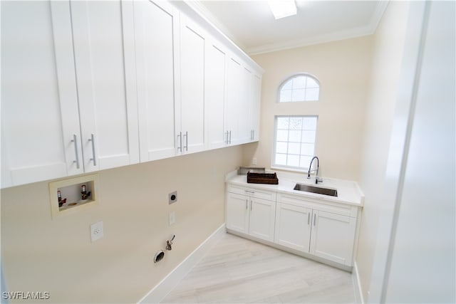 washroom featuring cabinets, hookup for an electric dryer, hookup for a gas dryer, crown molding, and sink