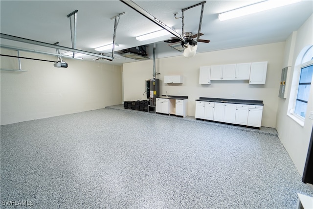 garage with a garage door opener and water heater