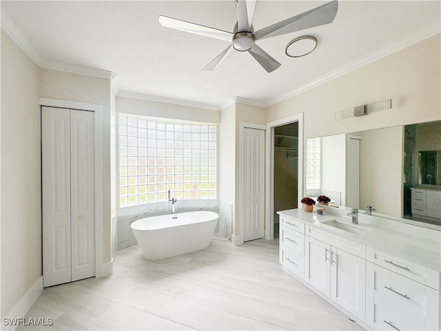 bathroom with vanity, a tub to relax in, ornamental molding, and ceiling fan