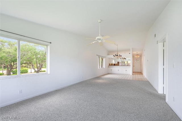 4130 Looking Glass Ln Unit 3802, Naples, FL 34112 - unfurnished living room with light carpet, plenty of natural light, ceiling fan, a chandelier, and vaulted ceiling