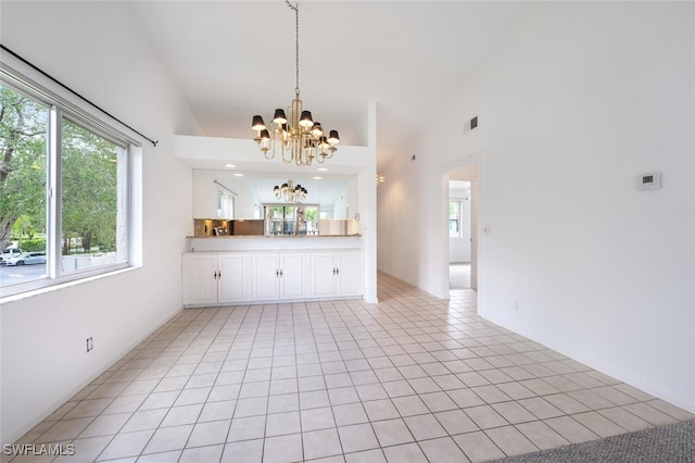 4130 Looking Glass Ln Unit 3802, Naples, FL 34112 - unfurnished living room featuring a chandelier, healthy amount of natural light, lofted ceiling, and light tile patterned floors