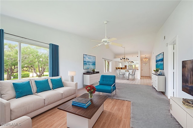 4130 Looking Glass Ln Unit 3802, Naples, FL 34112 - living room with plenty of natural light, a ceiling fan, lofted ceiling, light wood-style floors, and a chandelier