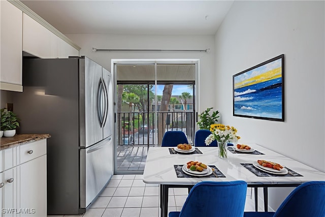 4130 Looking Glass Ln Unit 3802, Naples, FL 34112 - kitchen featuring freestanding refrigerator, white cabinetry, and light tile patterned floors