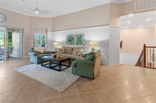 living room featuring ceiling fan, ornamental molding, and light tile patterned floors