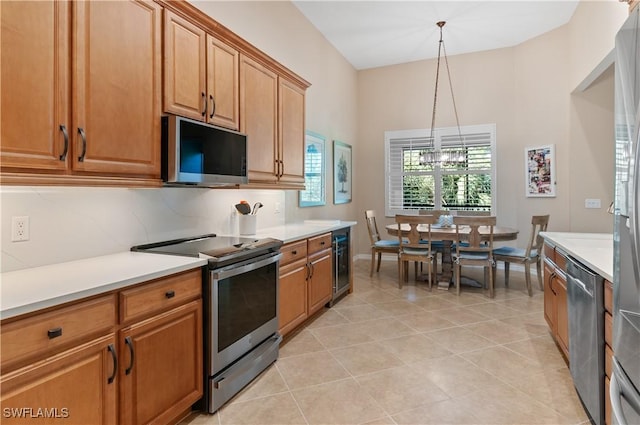 kitchen with wine cooler, light tile patterned flooring, hanging light fixtures, stainless steel appliances, and backsplash