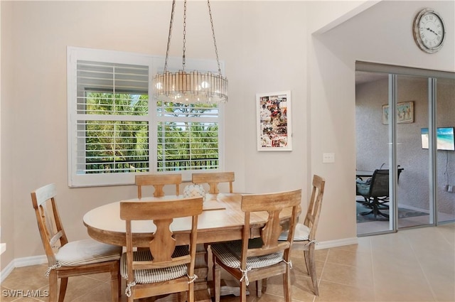 tiled dining space featuring a chandelier