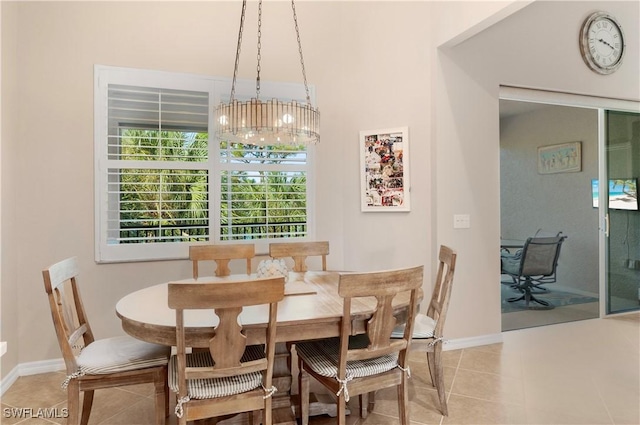 dining space with tile patterned flooring and a notable chandelier