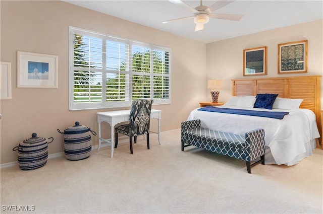 bedroom with ceiling fan and light carpet