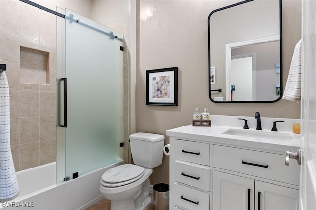 full bathroom featuring vanity, combined bath / shower with glass door, and toilet