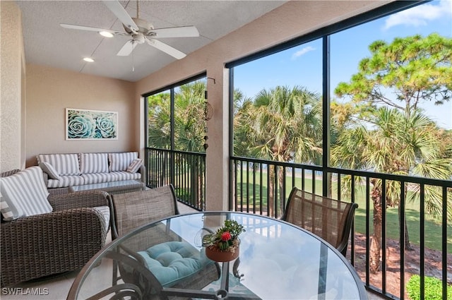 sunroom featuring ceiling fan