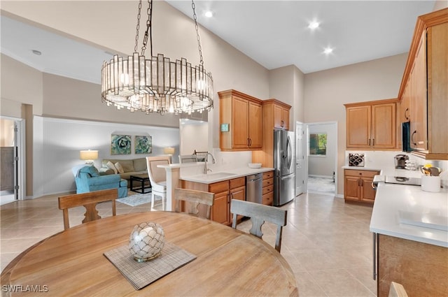 kitchen featuring light tile patterned floors, an inviting chandelier, a high ceiling, stainless steel refrigerator with ice dispenser, and decorative light fixtures