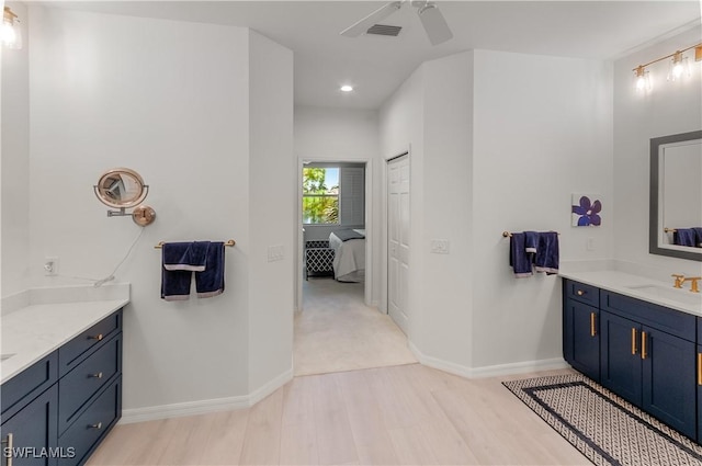 bathroom with vanity, wood-type flooring, and ceiling fan