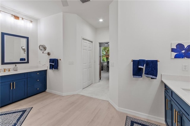 bathroom featuring vanity, hardwood / wood-style floors, and ceiling fan