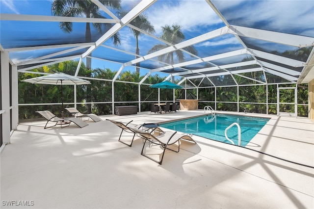 view of pool with a lanai and a patio area