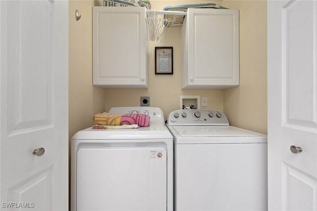 laundry room with cabinets and washer and dryer