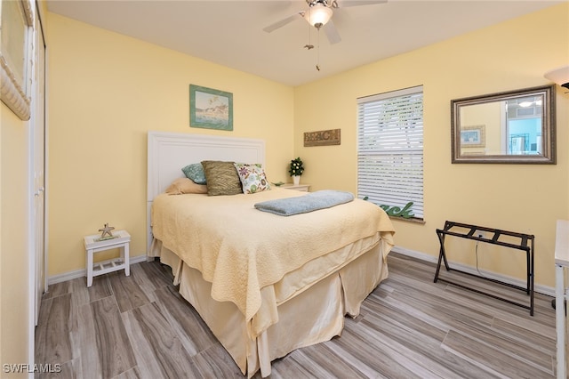 bedroom featuring light wood-type flooring and ceiling fan