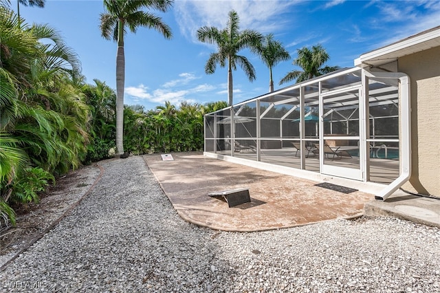 view of patio / terrace featuring a lanai