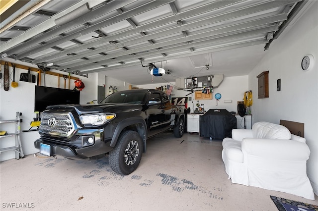 garage featuring electric panel and a garage door opener