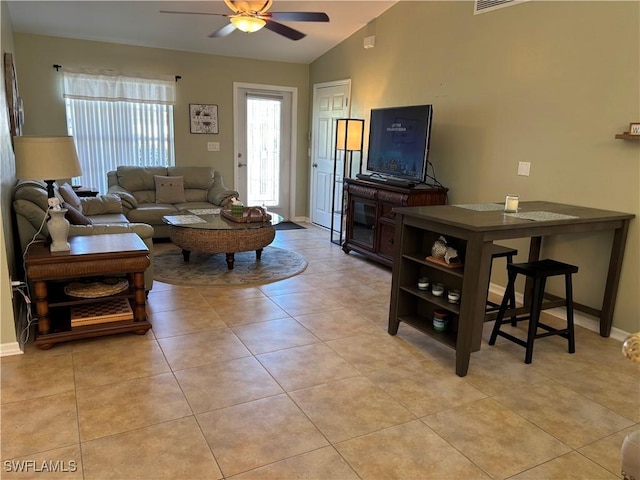 tiled living room with ceiling fan and lofted ceiling