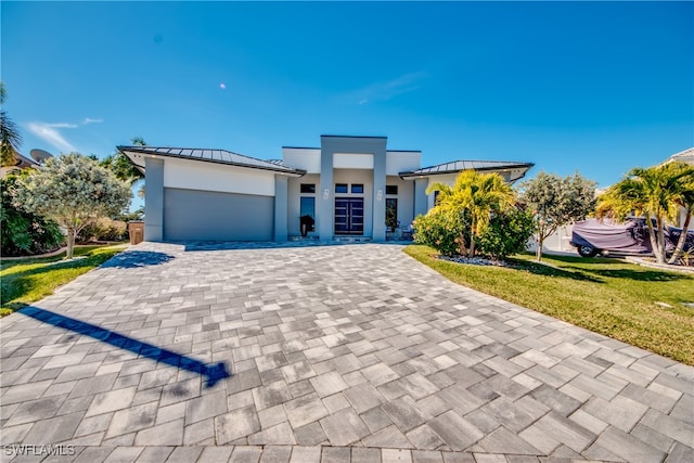 view of front facade featuring a front yard and a garage