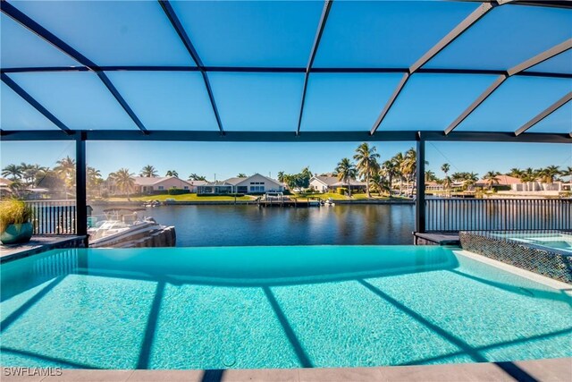 view of pool featuring a lanai and a water view